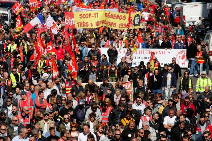 French CGT labour union workers hold flags during a demonstration to protest against the French government's reforms in Marseille